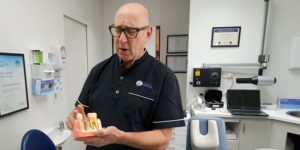 Dr Finkelstein holding Dental implants model