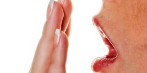 A woman holding her hand to her mouth