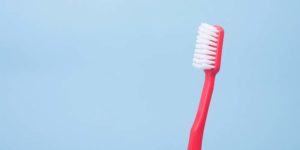 Red toothbrush on a blue background