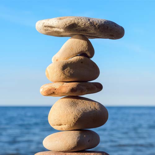 A rock cairn on the sea shore to represent holistic dentistry