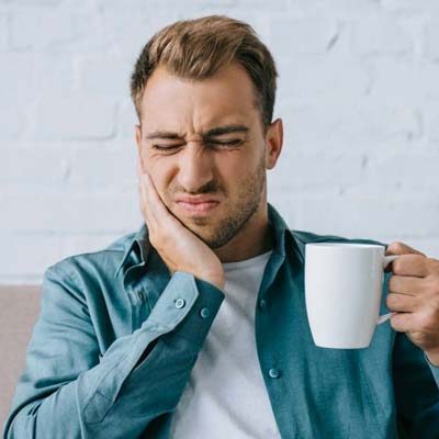 Emergency Dentist Sydney man in pain with a toothache